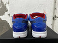 Rear view of blue Nike Kobe basketball shoes with red collars and star-patterned heel details.