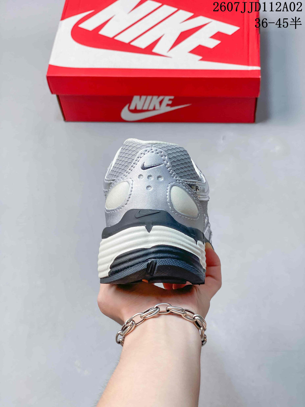 Rear view of a silver-toned Nike P-6000 sneaker