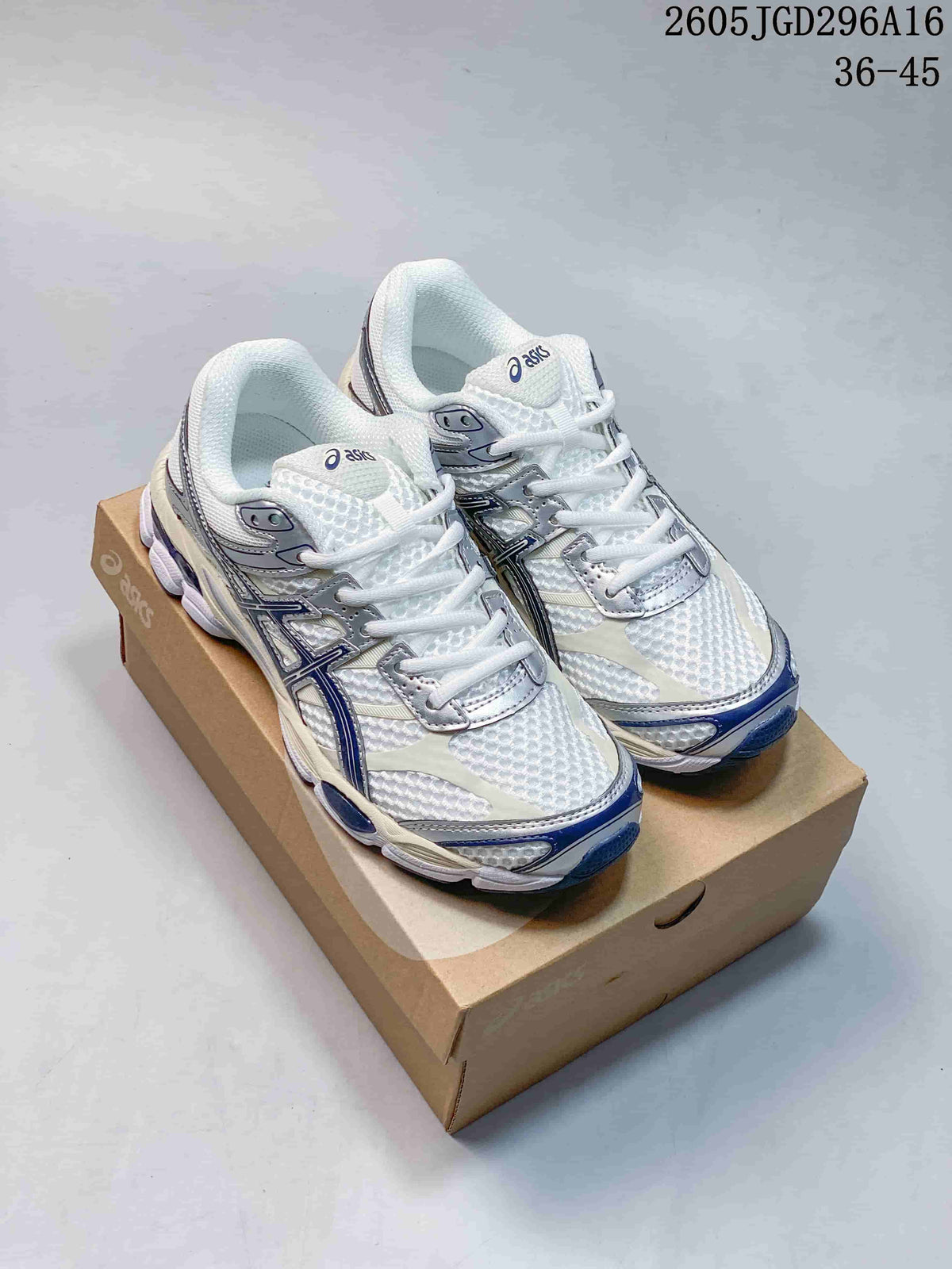 Pair of white ASICS Gel-Cumulus 16 sneakers with silver overlays and navy accents, shown on a shoebox.