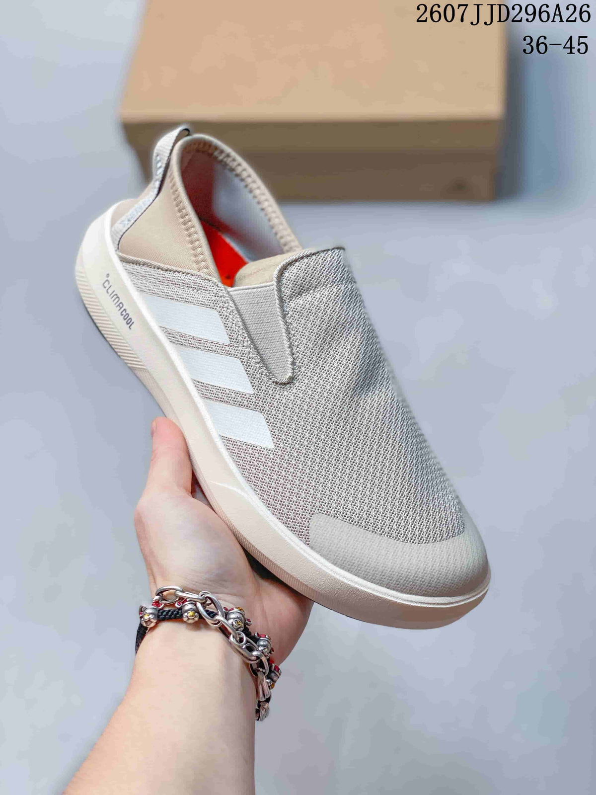 Three-quarter view showing the light gray upper, three side stripes, Climacool marking, white midsole, and black outsole.