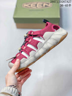 Side view of a burgundy KEEN outdoor sandal showing the open strap construction, light midsole, and gum-colored outsole.