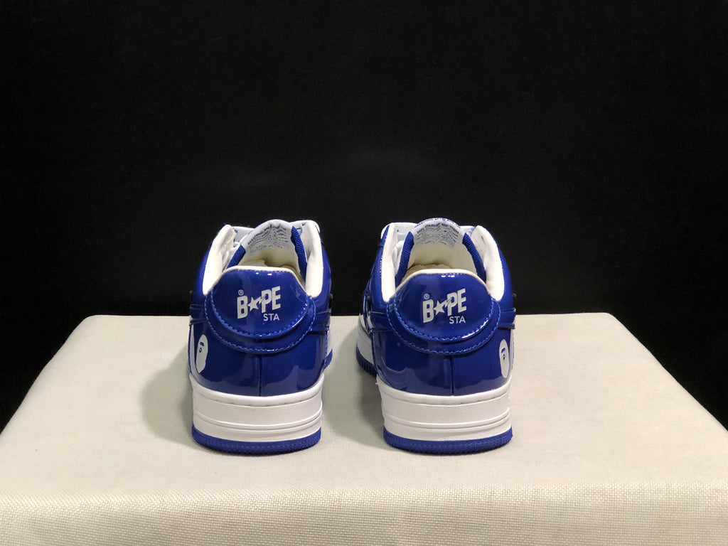 Rear view showing the blue heel panels, Bape Sta branding, white midsoles, and blue outsoles.