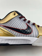 Close-up of the side logo, striped panel, gold overlays, and white midsole.