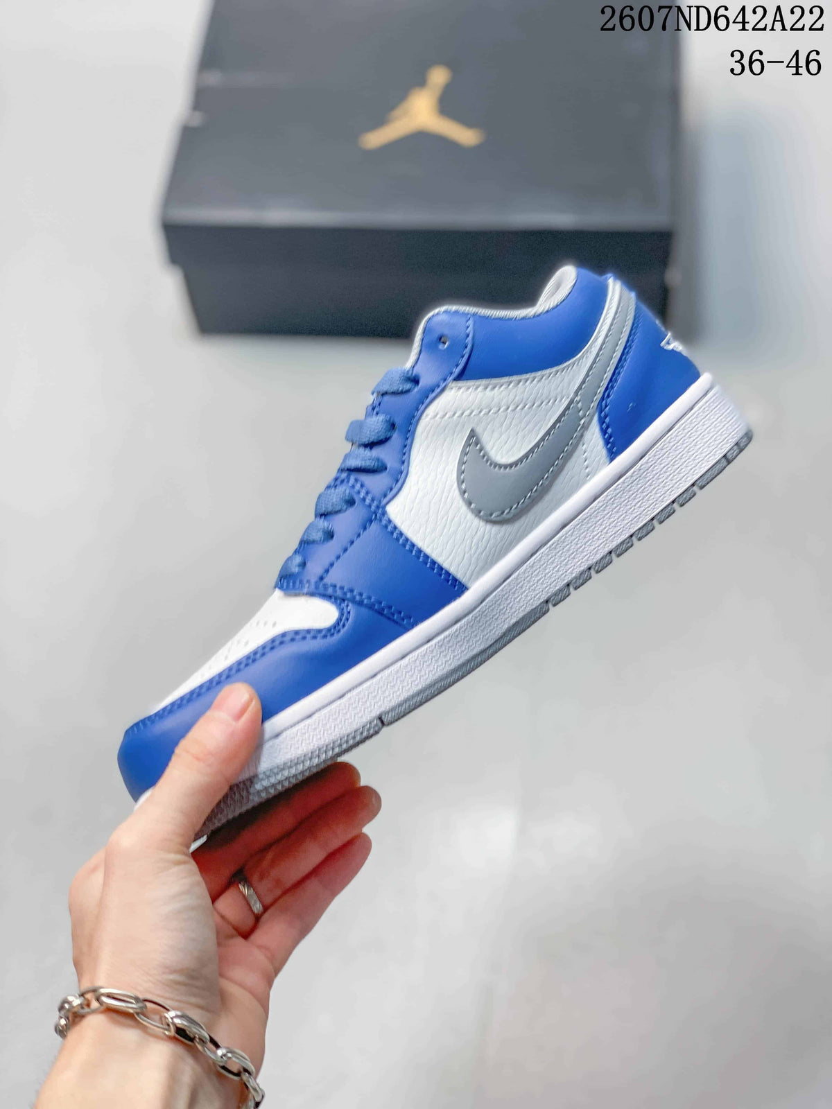Side profile showing the blue and white upper, grey Swoosh, white midsole, and outsole; image text shows sizes 36–46.