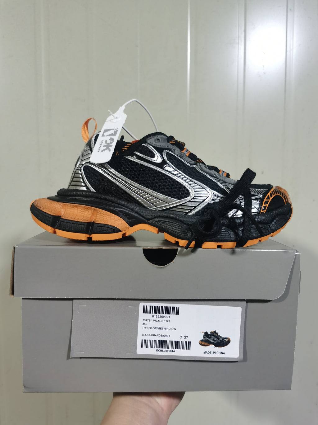 Black, orange, and grey sneaker displayed on its shoebox; the box label shows product code 1178 and photographed size C 37.