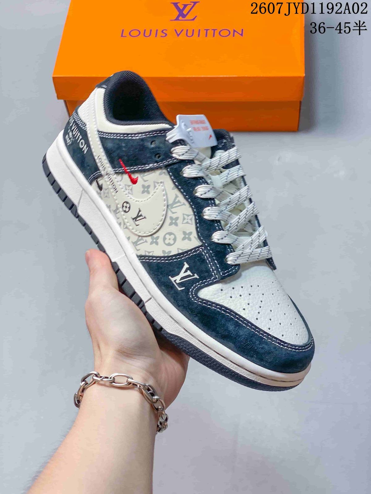 Hand-held side view of a white and navy patterned low-top sneaker