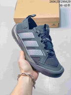 Angled side view of the dark gray Terrex sneaker showing the mesh construction, perforated overlays, reinforced toe, and rubber outsole.