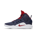 Side view of a navy and red Nike high-top basketball sneaker with a white sole.
