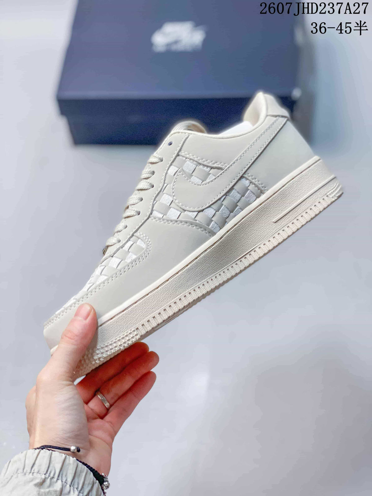 Side view of the sneaker showing the tonal swoosh, woven side panel, laces, and layered sole.