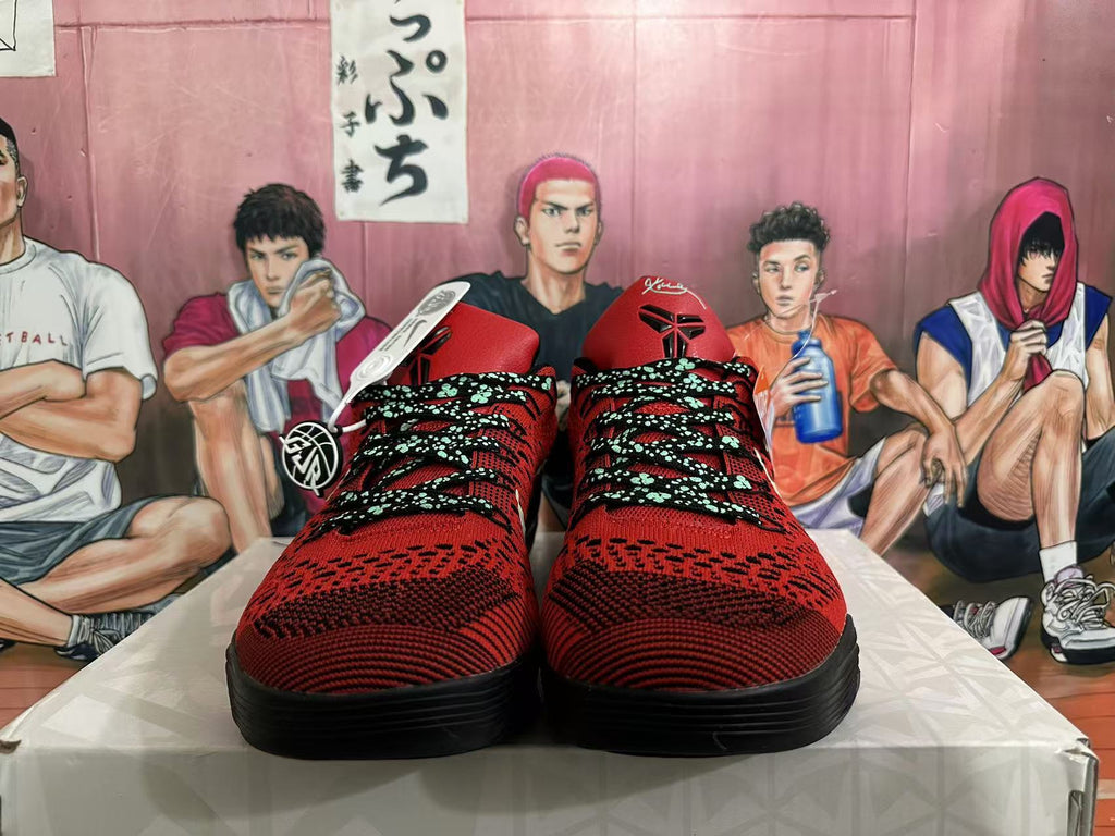 Front view of red and black basketball shoes with patterned uppers and contrasting laces.