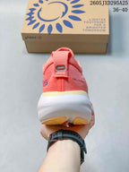 Rear view of the coral-pink shoe showing the heel and white midsole