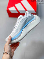 Side profile showing the white upper, gray layered panels, blue midsole accent, and curved heel.