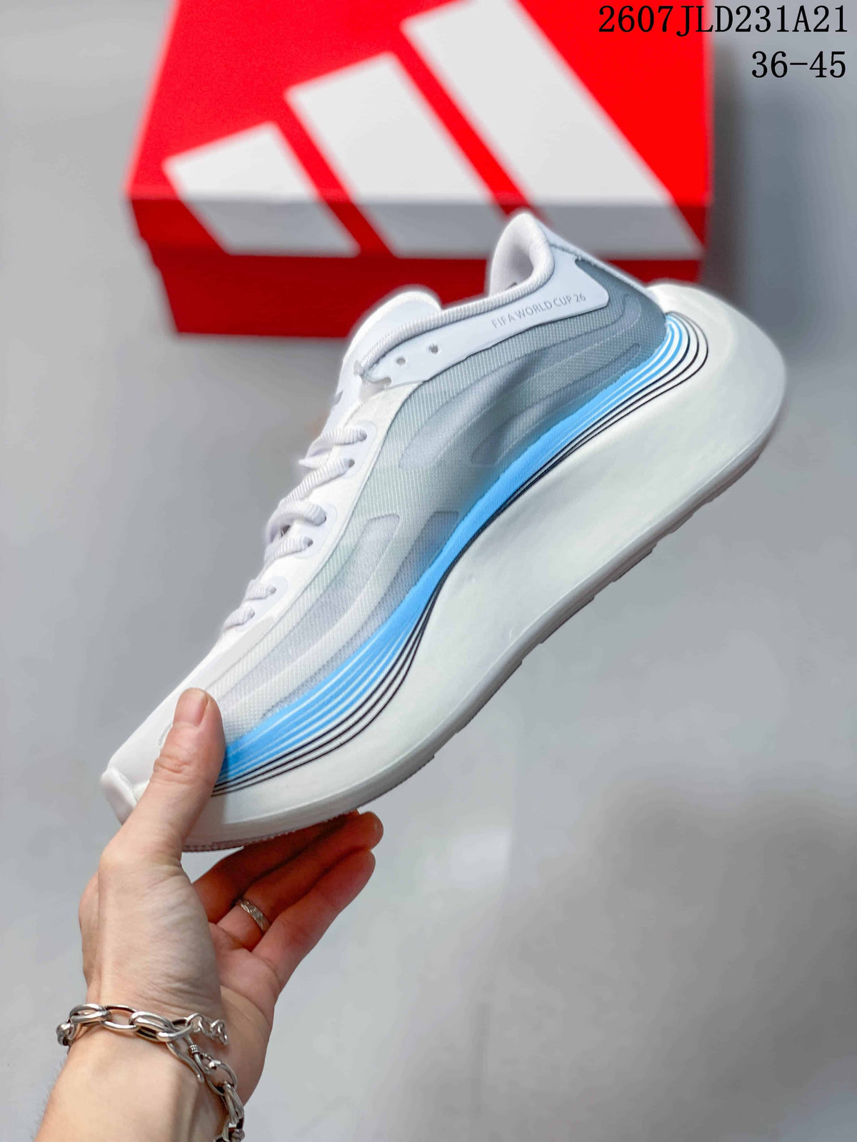 Side profile showing the white upper, gray layered panels, blue midsole accent, and curved heel.