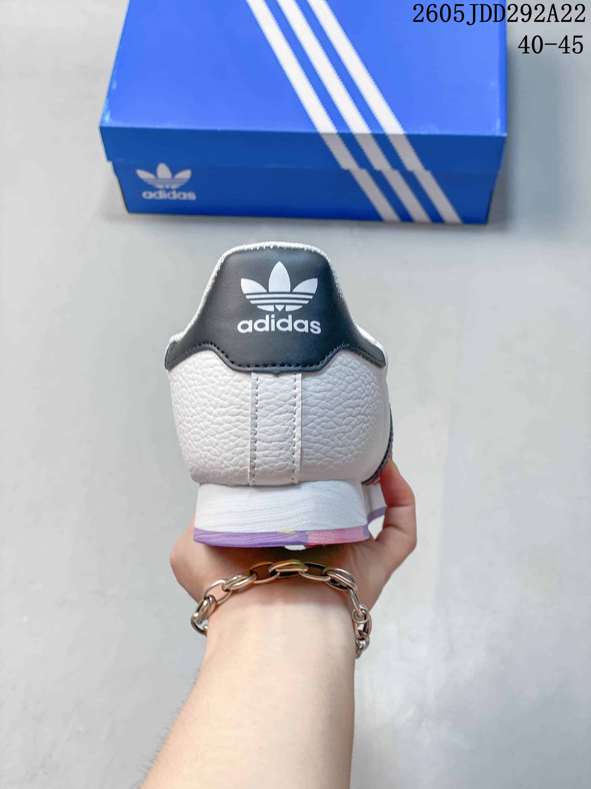 Rear view of the white adidas Samoa sneaker showing the black heel detail and adidas branding.