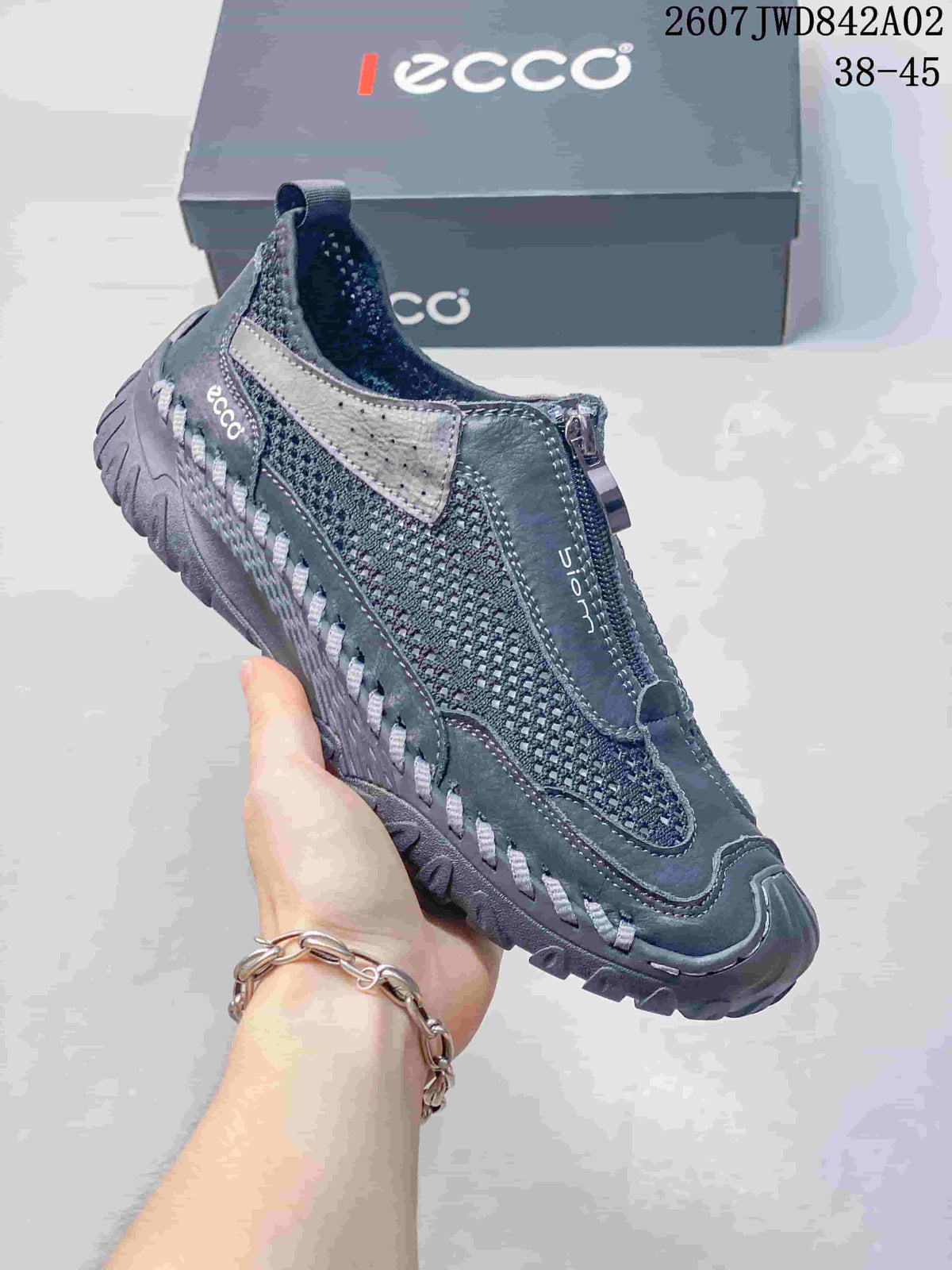 Side view of a charcoal gray ECCO shoe showing its front zipper and rugged outsole.