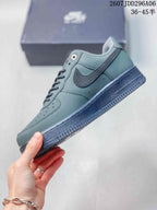 Side profile showing the gray-green upper, tonal Swoosh, perforated forefoot and dark rubber sole.