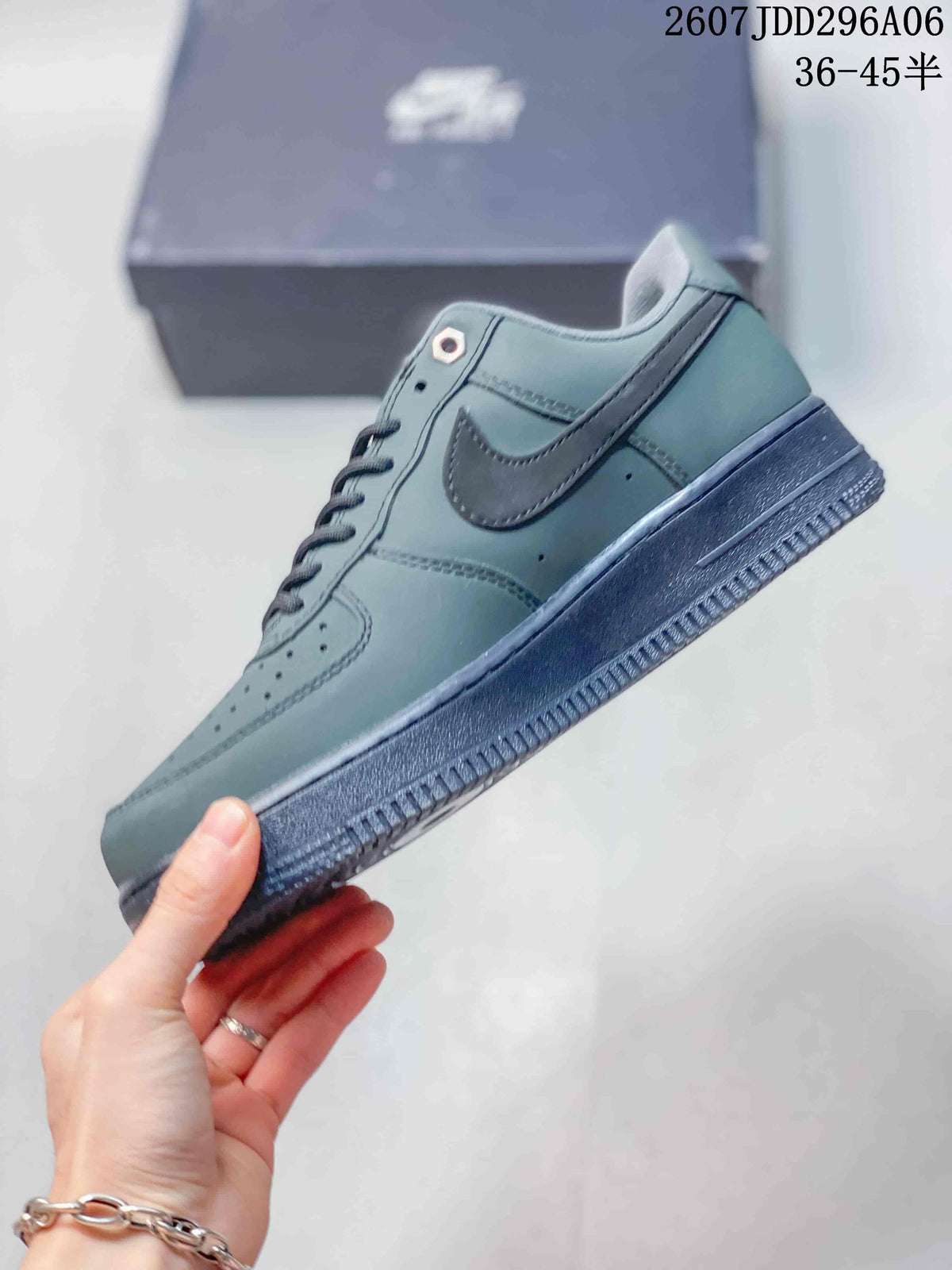 Side profile showing the gray-green upper, tonal Swoosh, perforated forefoot and dark rubber sole.