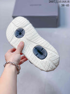 Bottom view of an off-white clog sandal showing the patterned outsole and dark footbed inserts.