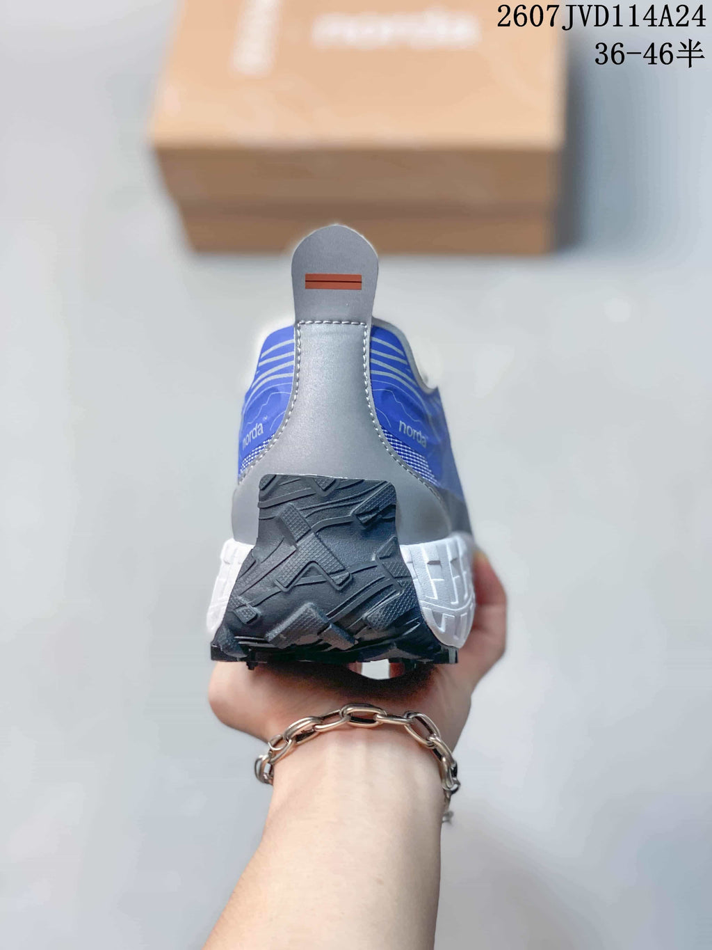 Rear view of the blue and gray NORDA sneaker with a contrasting heel pull tab and rugged outsole.