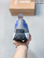 Rear view of the blue and gray NORDA sneaker with a contrasting heel pull tab and rugged outsole.