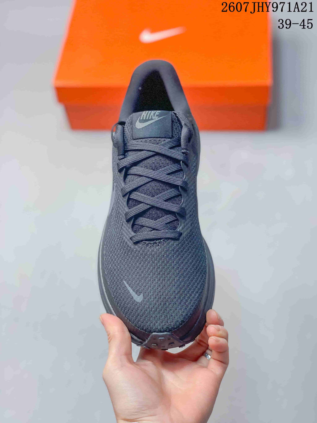 Top view of the black sneaker showing the lace configuration, textured toe box, and tongue branding.
