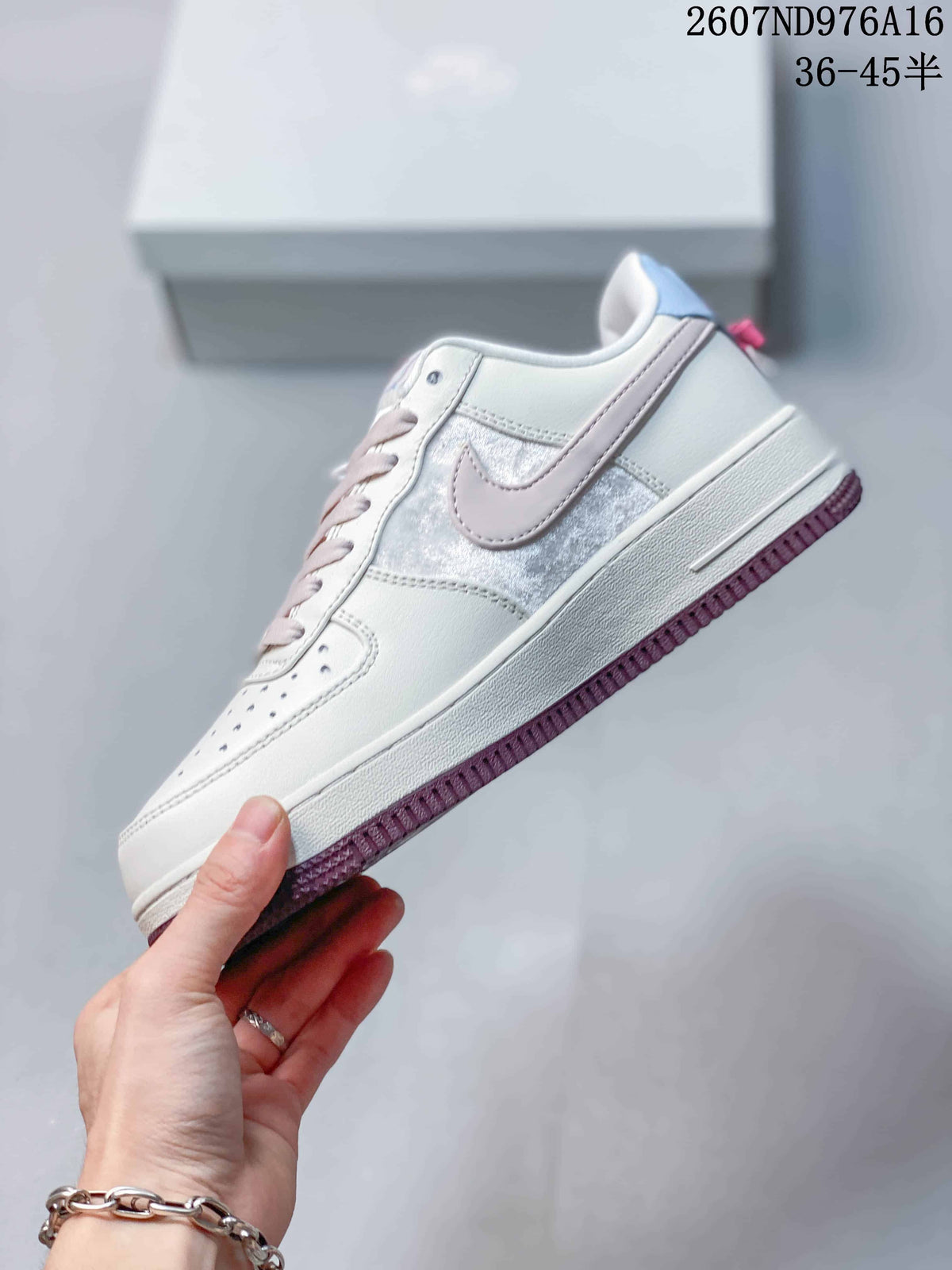 Side profile showing the white upper, pale pink Swoosh, white midsole and dark pink outsole.