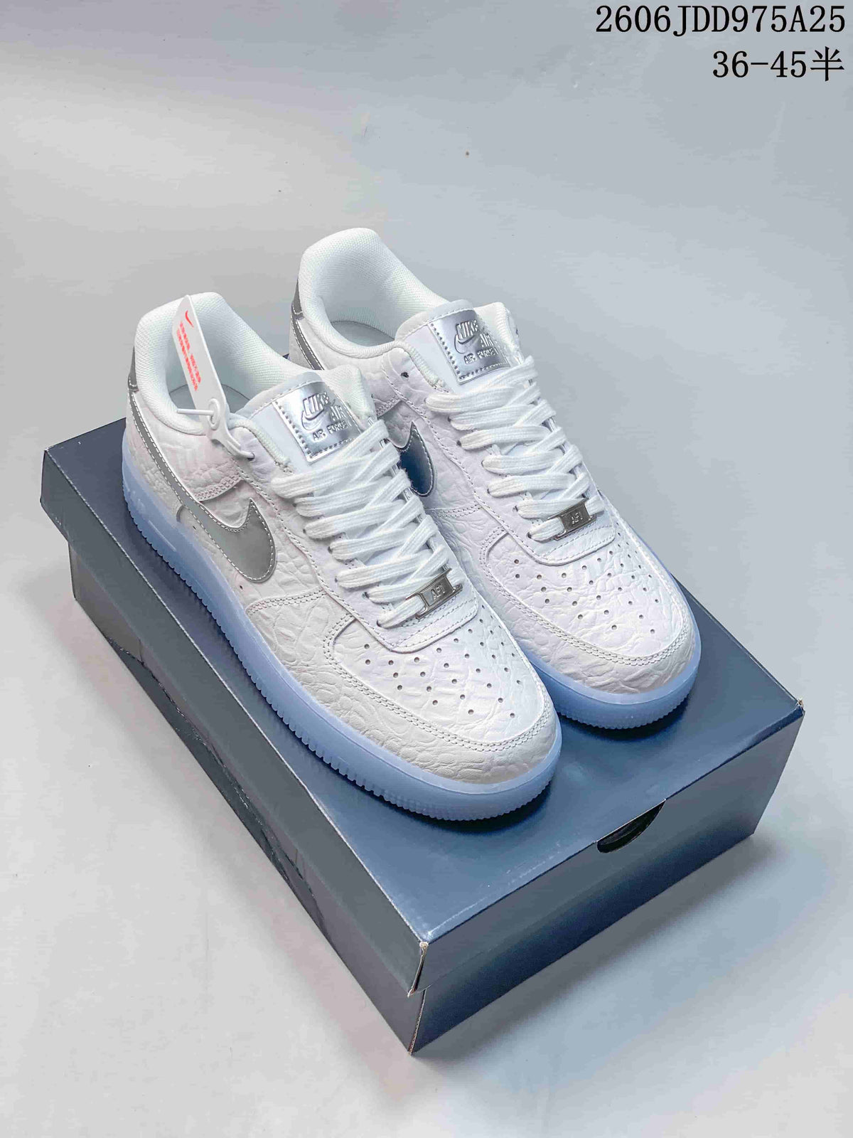 White low-top Air Force 1 sneakers with silver Swoosh details and icy blue soles