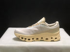 Lateral profile showing the streamlined upper and segmented cream midsole.