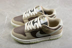 Three-quarter view of the low-top beige and brown sneakers with white midsoles and light green outsoles.