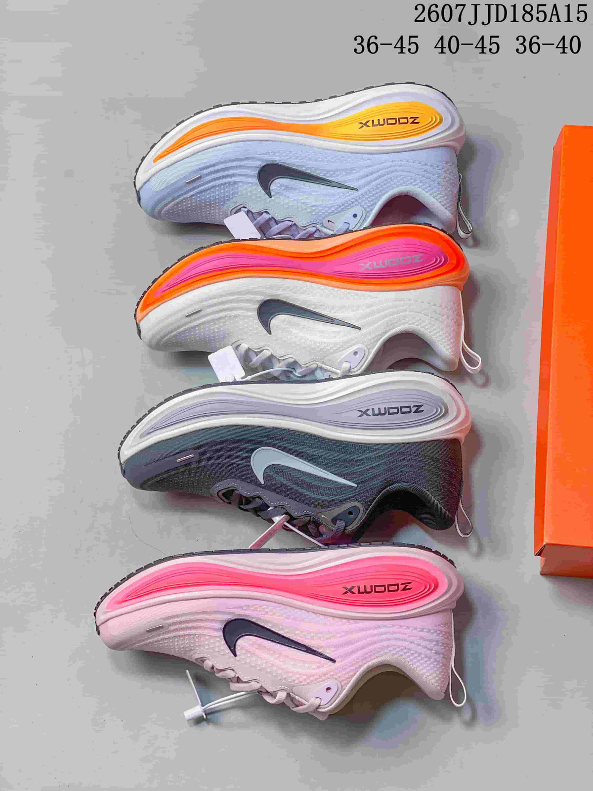 Four Nike Vomero Plus colorways arranged side by side, including light blue-white, pink, and dark gray.