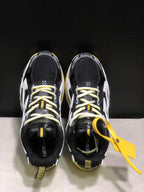 Top-down view showing the lace-up layout, black mesh uppers, contrast laces, and yellow hangtag.