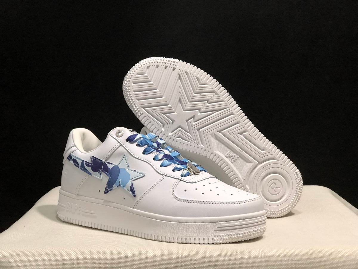 Angled view of the sneakers with one shoe lifted to reveal the white outsole and star-pattern tread.