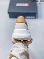 Rear view of a beige ECCO sneaker showing the tan heel accent, white heel section, and thick white sole.