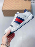 Side profile showing the perforated white upper, navy and red stripe panel, white midsole, and dark outsole.