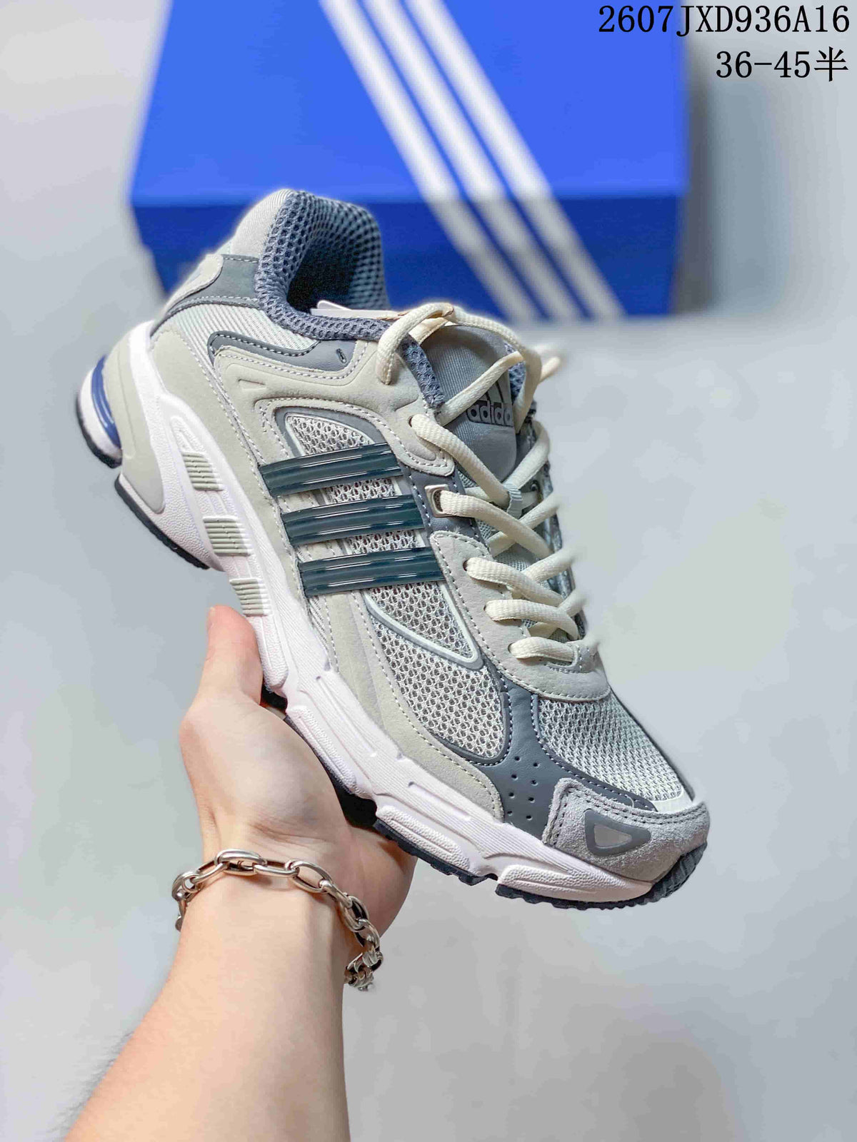 Three-quarter side view of the cream and gray adidas sneaker with mesh panels, layered overlays, and contrasting outsole.