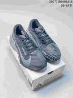 Pair of gray and black Nike ACG trail sneakers displayed on a shoe box.