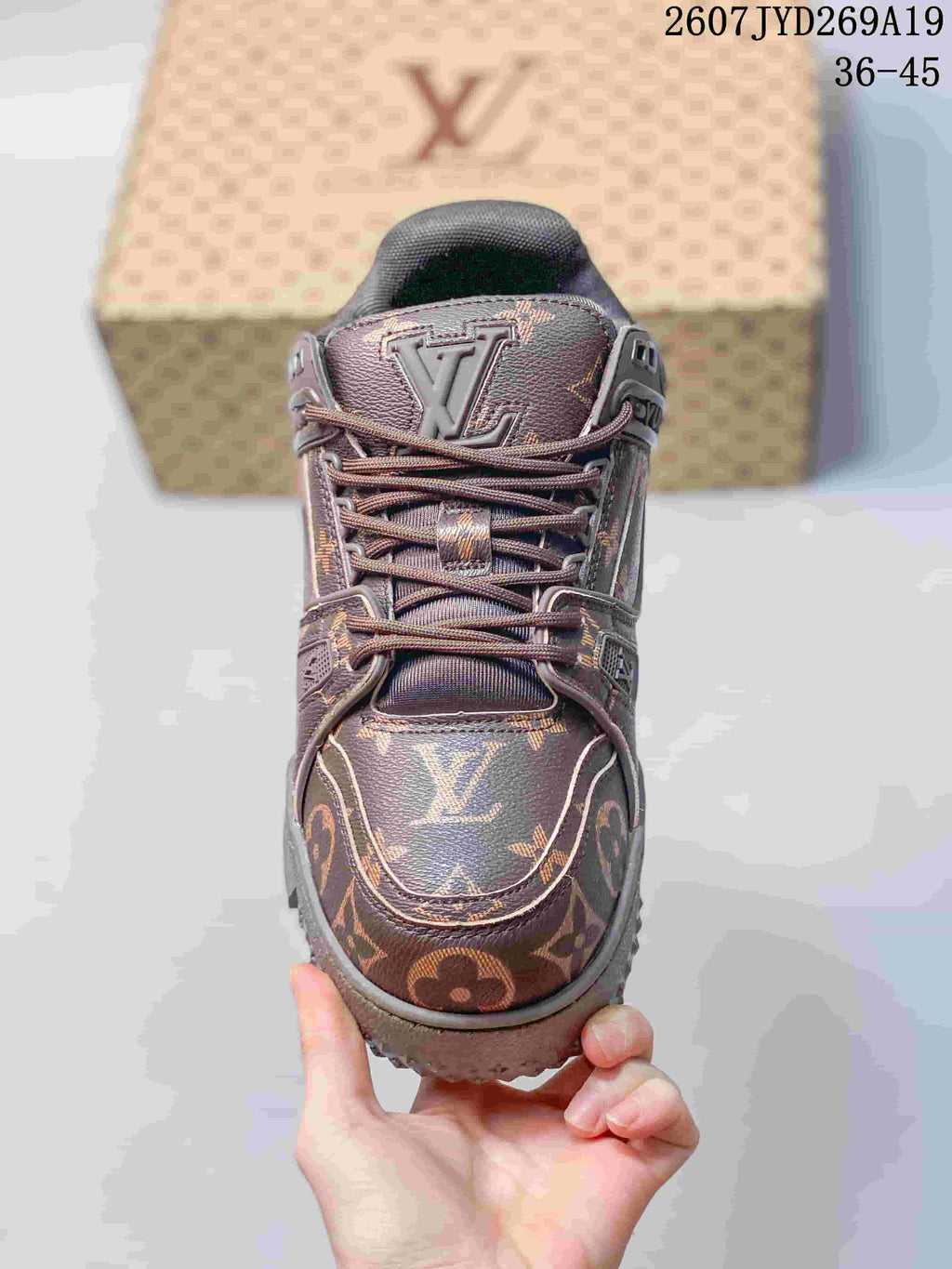 Top view of the sneaker showing the rounded toe, monogram pattern, tonal laces, and tongue logo.