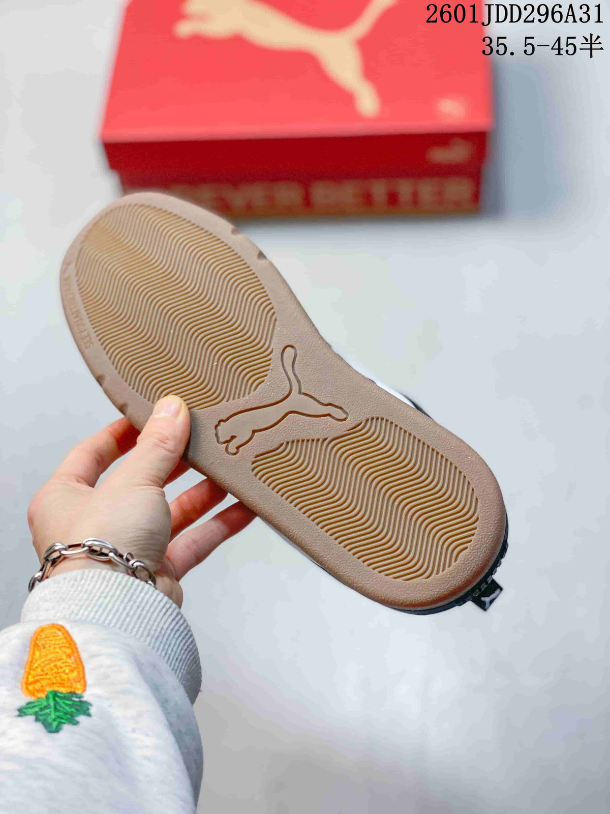 Underside of a PUMA sneaker showing a gum-colored outsole with a textured traction pattern and molded PUMA logo.