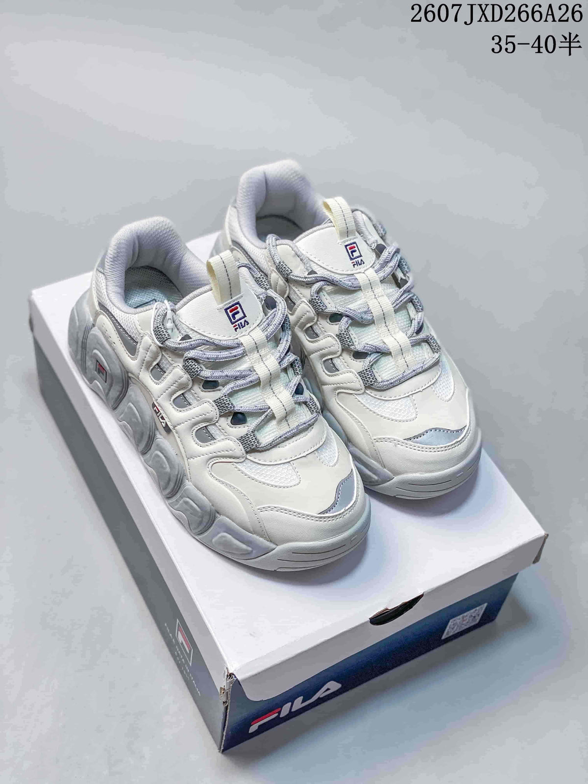 Pair of white and gray FILA Croissant low-top sneakers displayed on a FILA shoebox.