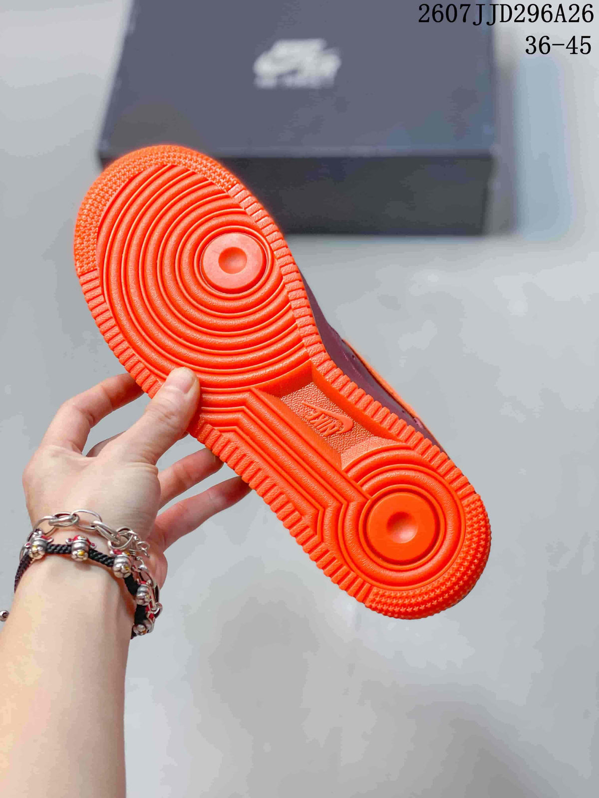 Close-up of the bright orange rubber outsole showing concentric circular traction patterns and textured edges.