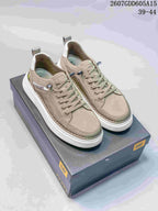 Taupe CAT casual sneakers with lace-up fronts, stitched panels, white outsoles and a branded shoe box.