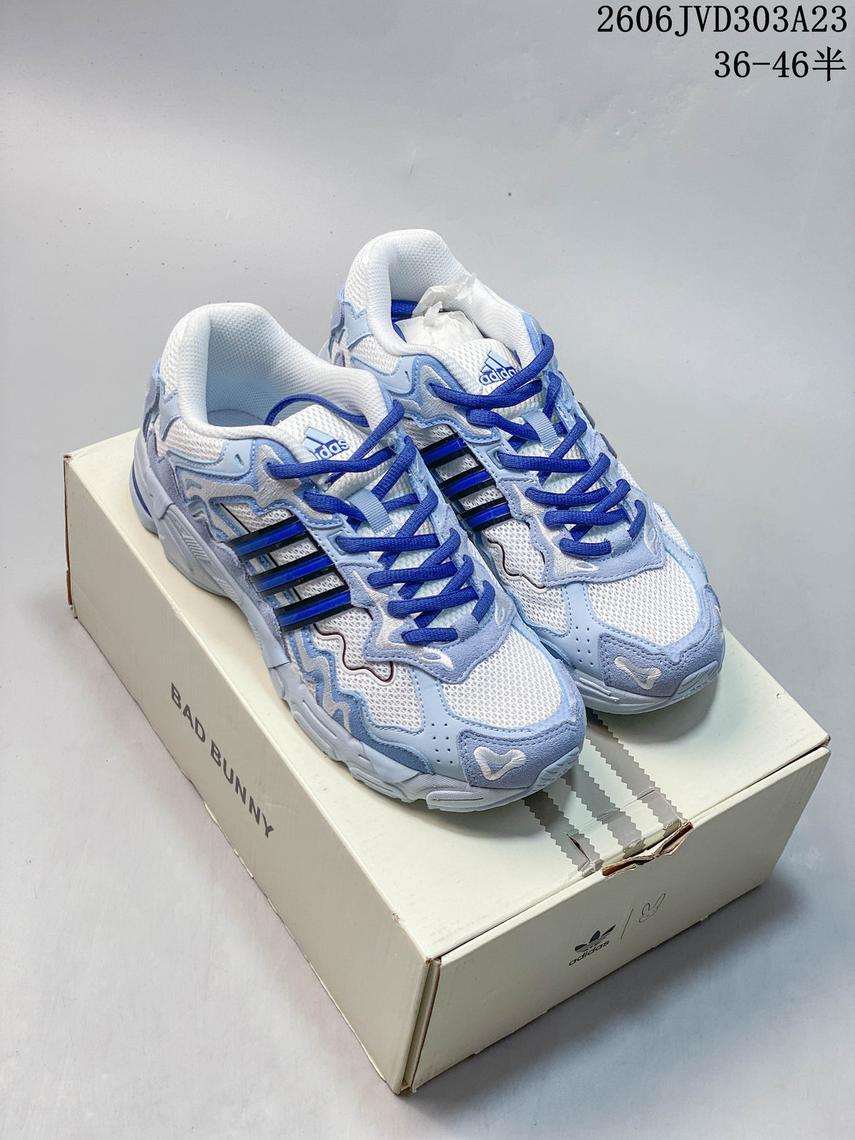 White and pale blue adidas Response CL sneakers with dark blue laces, shown on a Bad Bunny box.
