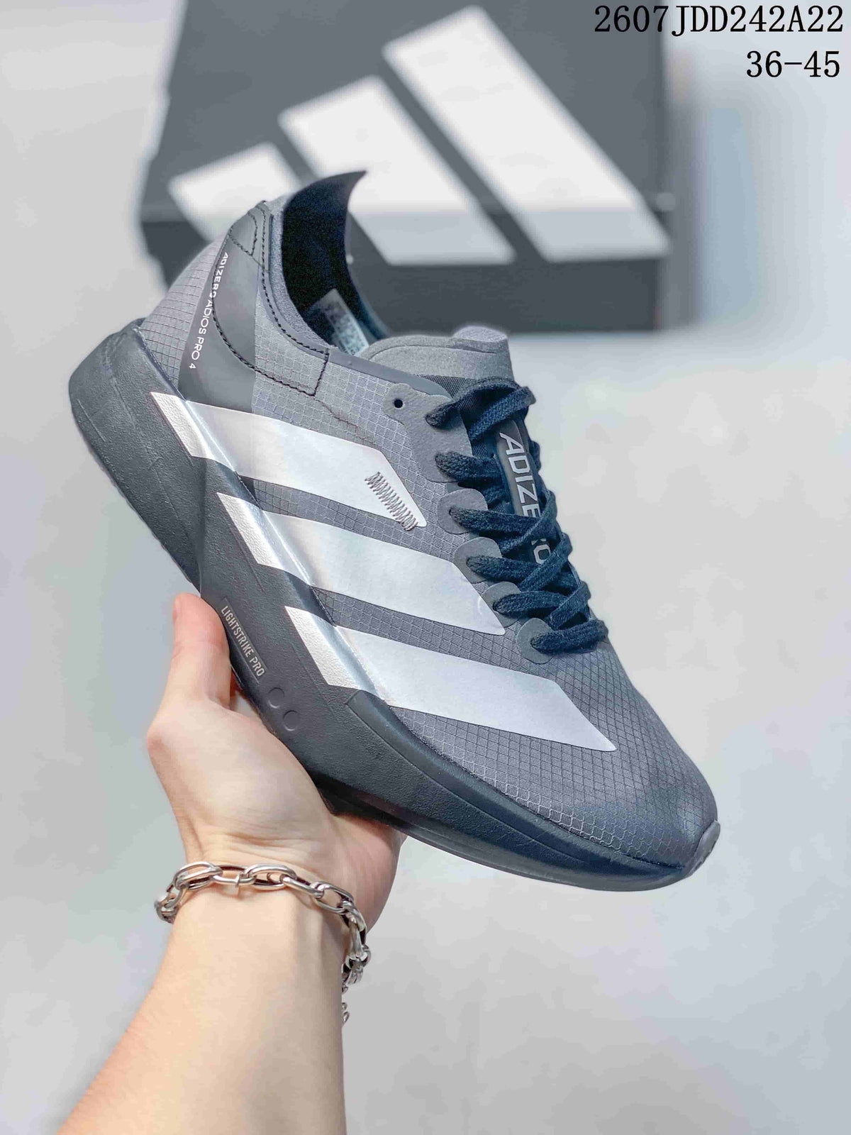 Gray Y-3 Adios Pro 4 sneaker with silver-toned side overlays and a dark sole; image text shows JDD242A22 and sizes 36–45.