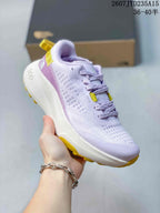 Angled side view of the light purple and white hiking shoe with yellow outsole details and a sculpted midsole.