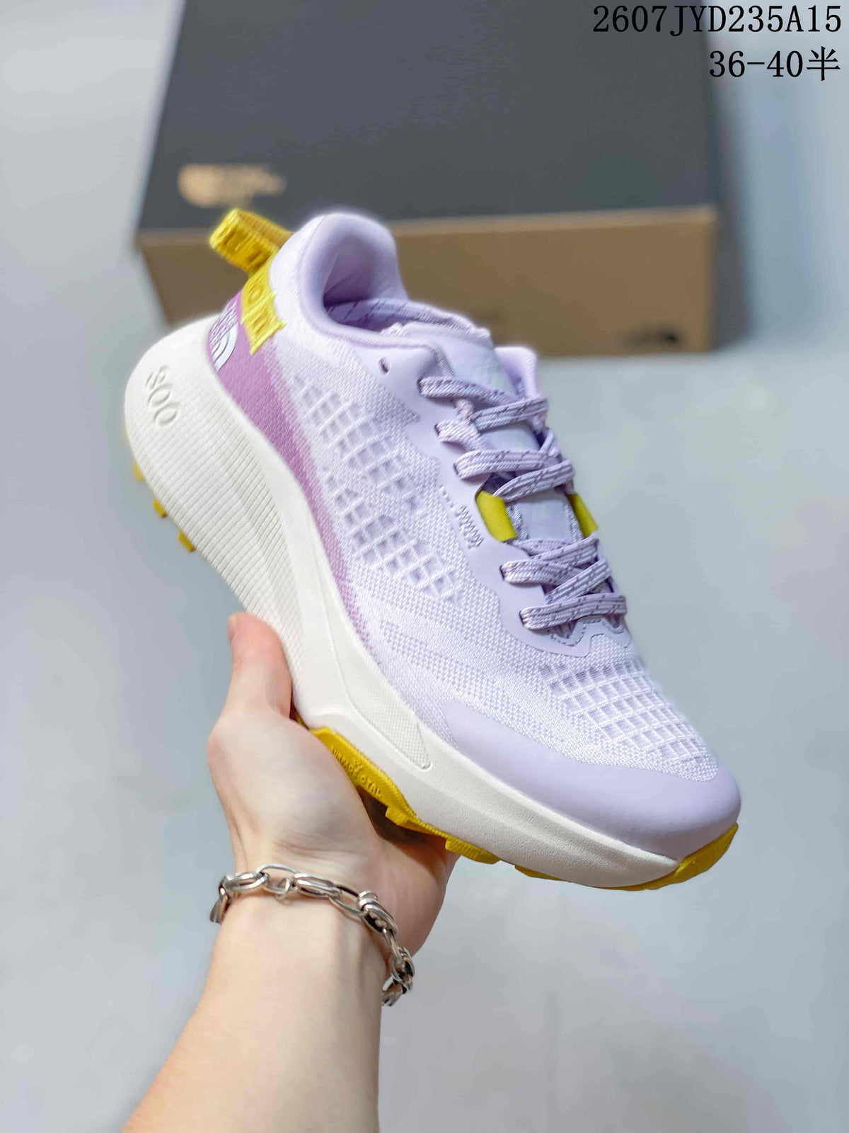 Angled side view of the light purple and white hiking shoe with yellow outsole details and a sculpted midsole.