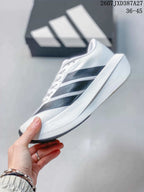 Side view showing the white upper, black patterned stripes, and raised midsole.