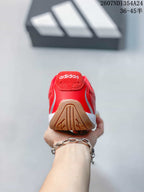 Rear view of the red sneaker showing the padded heel, adidas tongue branding, and outsole detail.