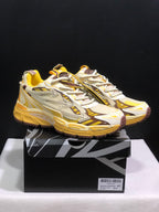 Pair of yellow, cream, and brown Off-White Be Right Back sneakers displayed on a branded shoe box.