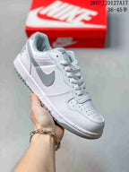 White and gray Nike SB Dunk Low Pro sneaker with a gray Swoosh and gray outsole.