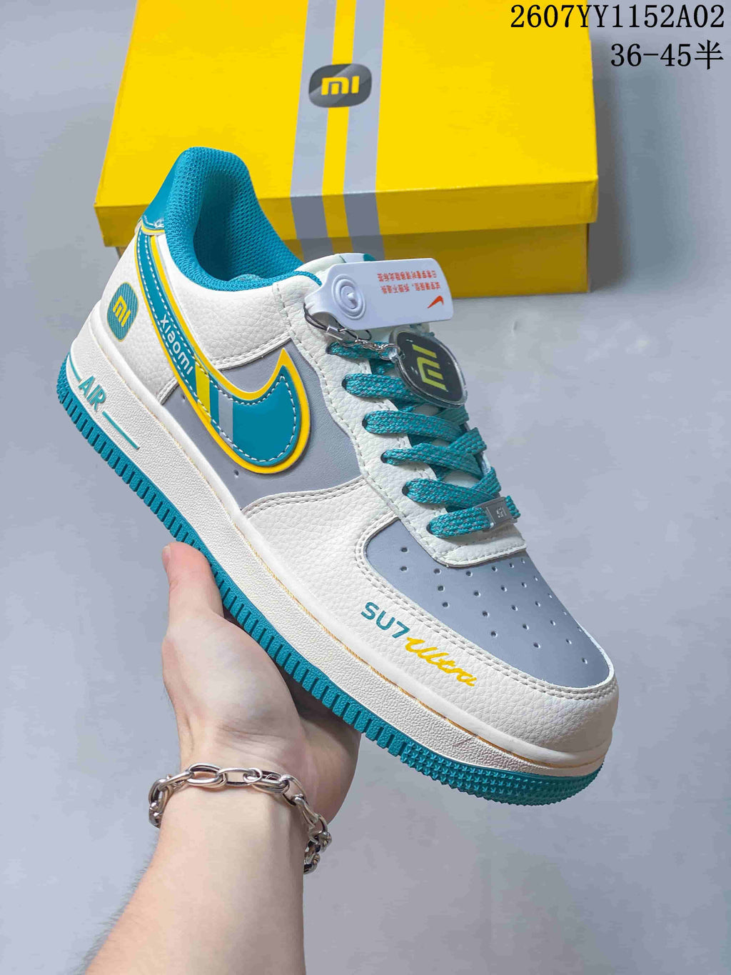 Angled view showing the sneaker's side details, turquoise outsole and Xiaomi-themed accents